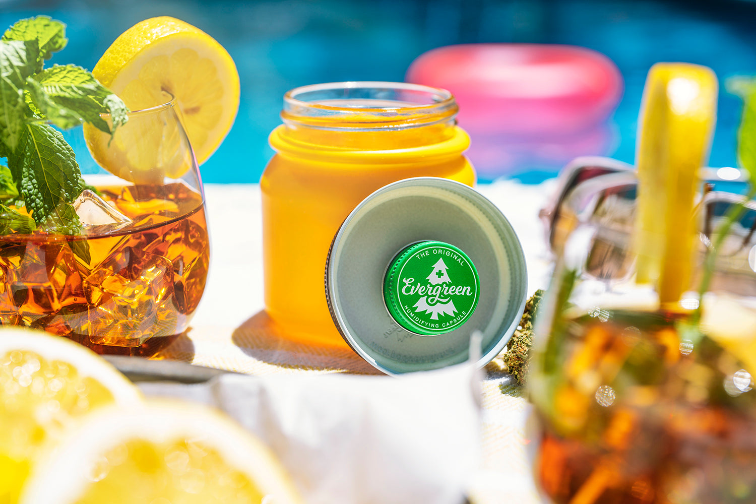 Evergreen Storage Solution jar open on table showing pod against a summery background