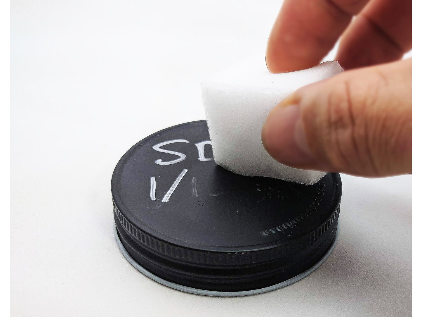 Erasing writing from Evergreen jar lid